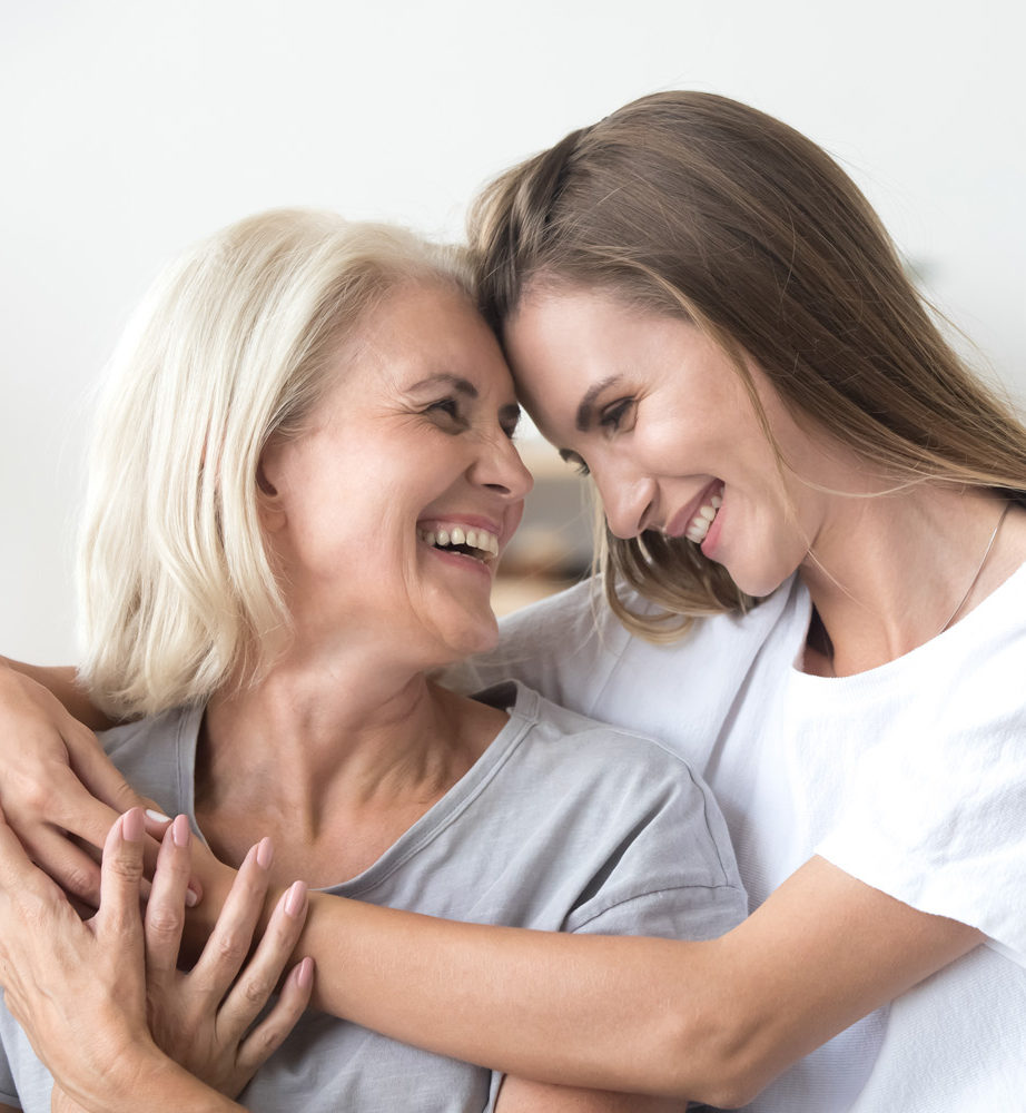 Two women smiling and hugging each other